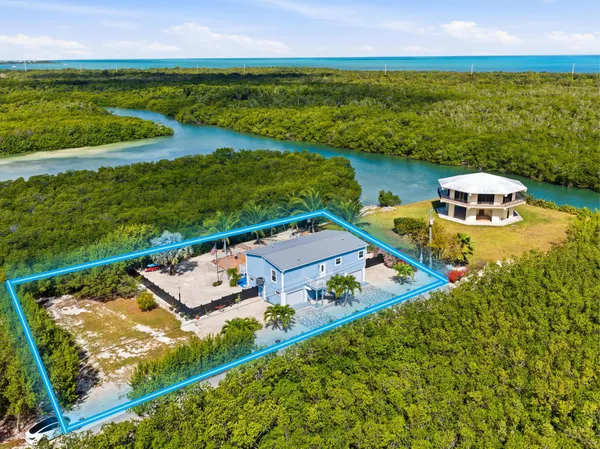 an aerial view of a house with a ocean view