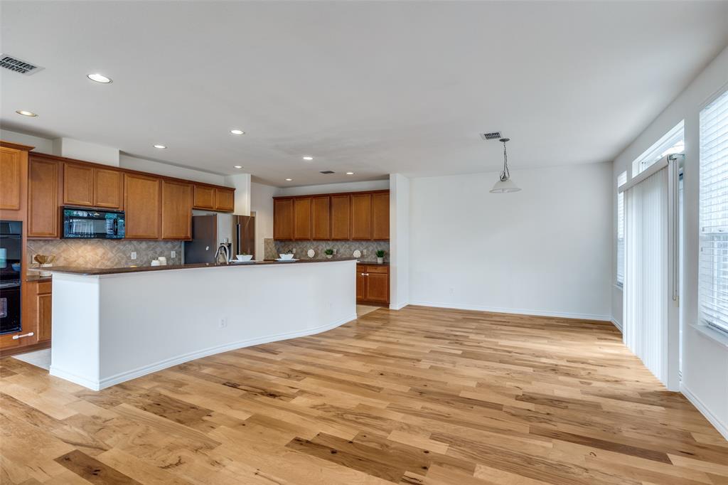 2025 Testament Trail Plano, TX 75074 - Photo 6 of 29 a view of kitchen with kitchen island wooden floor center island and stainless steel appliances
