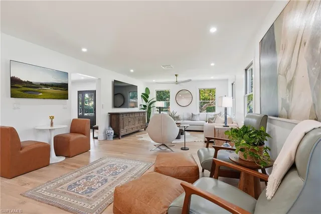 a living room with fireplace furniture and a flat screen tv