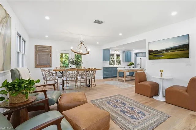 a living room with furniture a rug and a flat screen tv