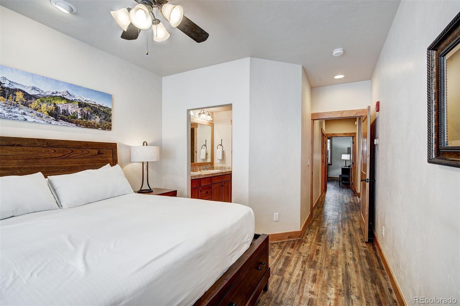 35 Tip Top Trail, Unit 6500 Keystone, CO 80435 - Photo 12 of 24 a bedroom with a large bed and a chandelier