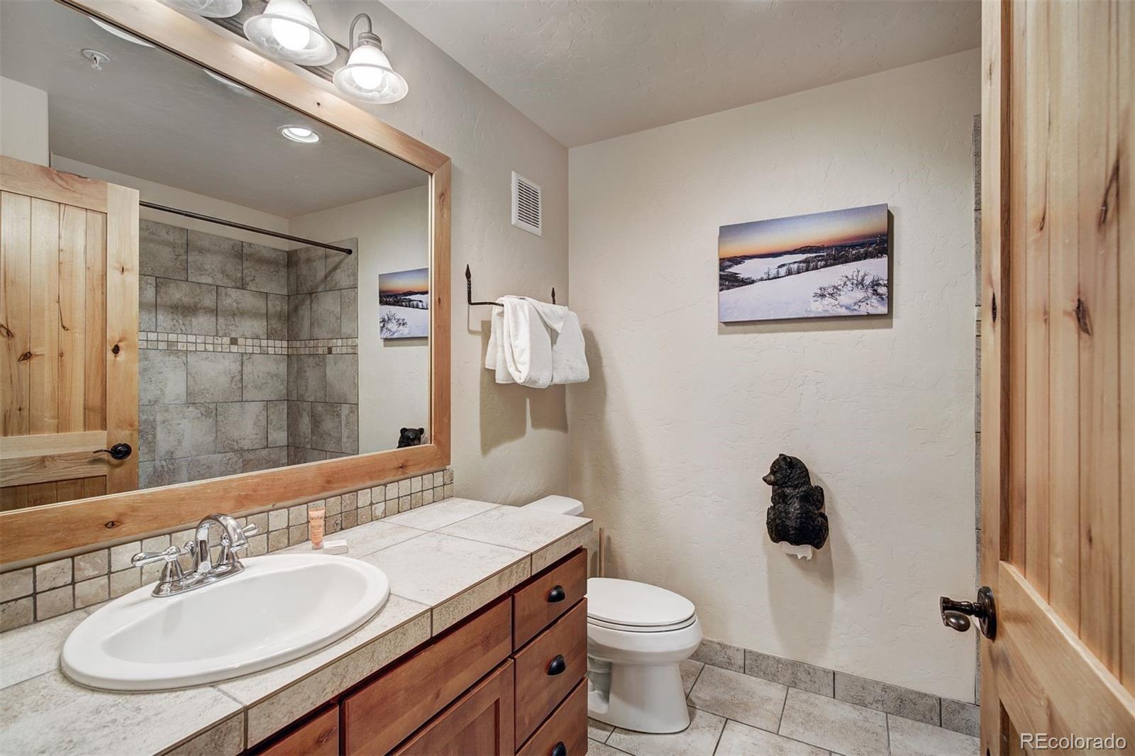 35 Tip Top Trail, Unit 6500 Keystone, CO 80435 - Photo 15 of 24 a bathroom with a sink a toilet a mirror and shower