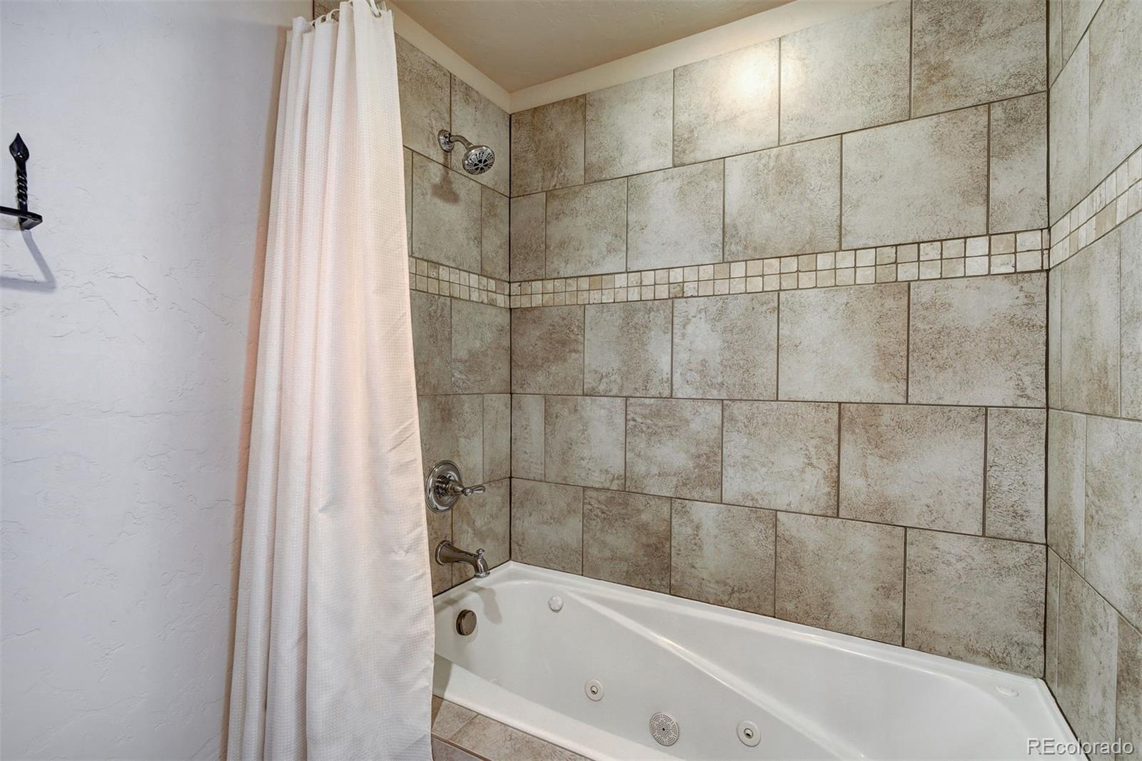 35 Tip Top Trail, Unit 6500 Keystone, CO 80435 - Photo 16 of 24 a bathroom with a bathtub