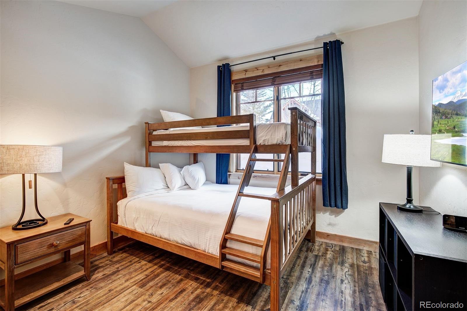 35 Tip Top Trail, Unit 6500 Keystone, CO 80435 - Photo 17 of 24 a bedroom with a bed and a flat tv screen on the dresser