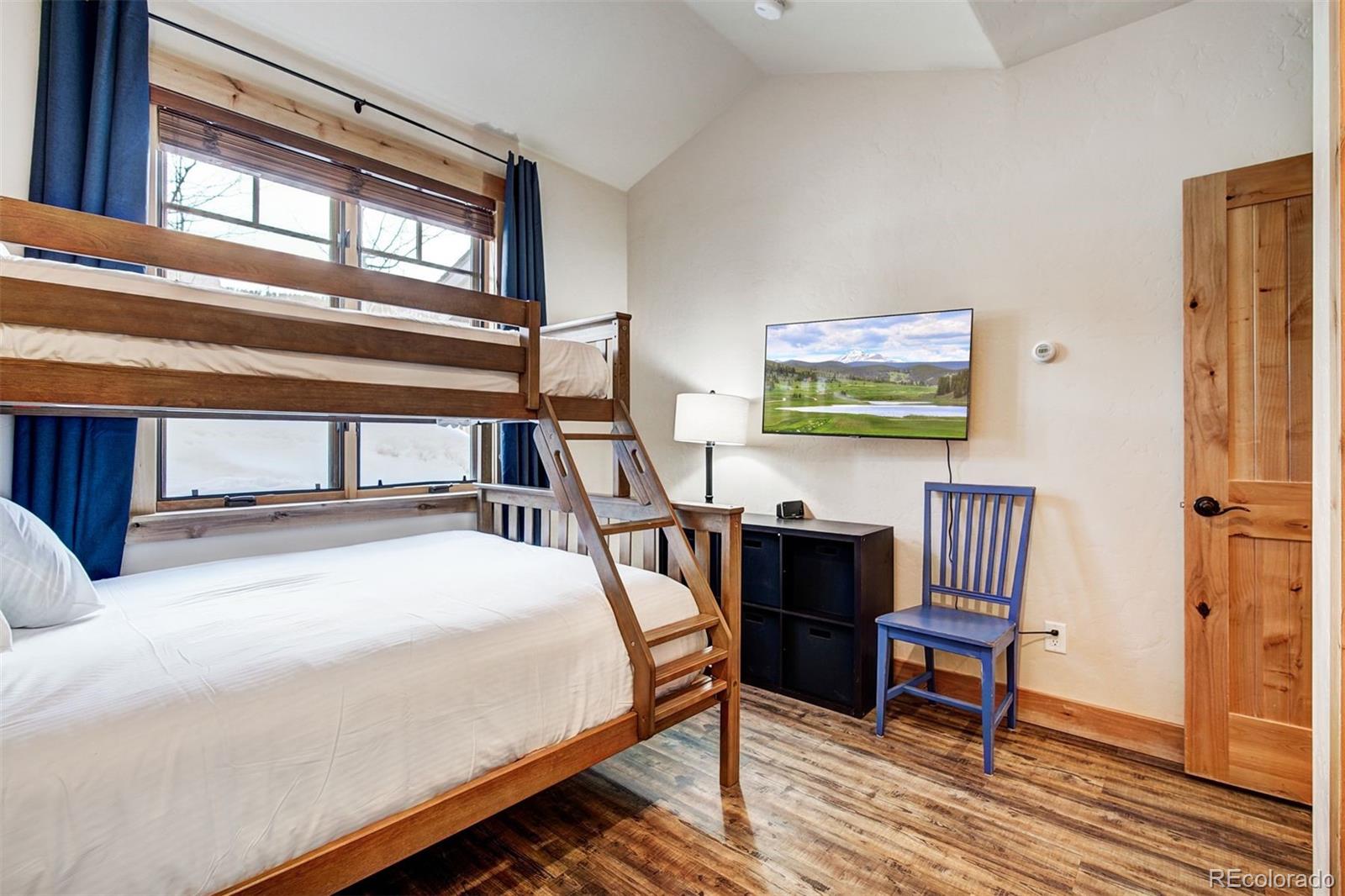 35 Tip Top Trail, Unit 6500 Keystone, CO 80435 - Photo 18 of 24 a bedroom with a bed wooden floor and a window