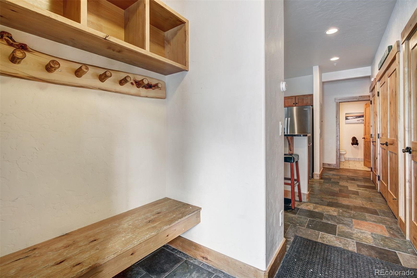 35 Tip Top Trail, Unit 6500 Keystone, CO 80435 - Photo 19 of 24 a view of a hallway with wooden floor and staircase
