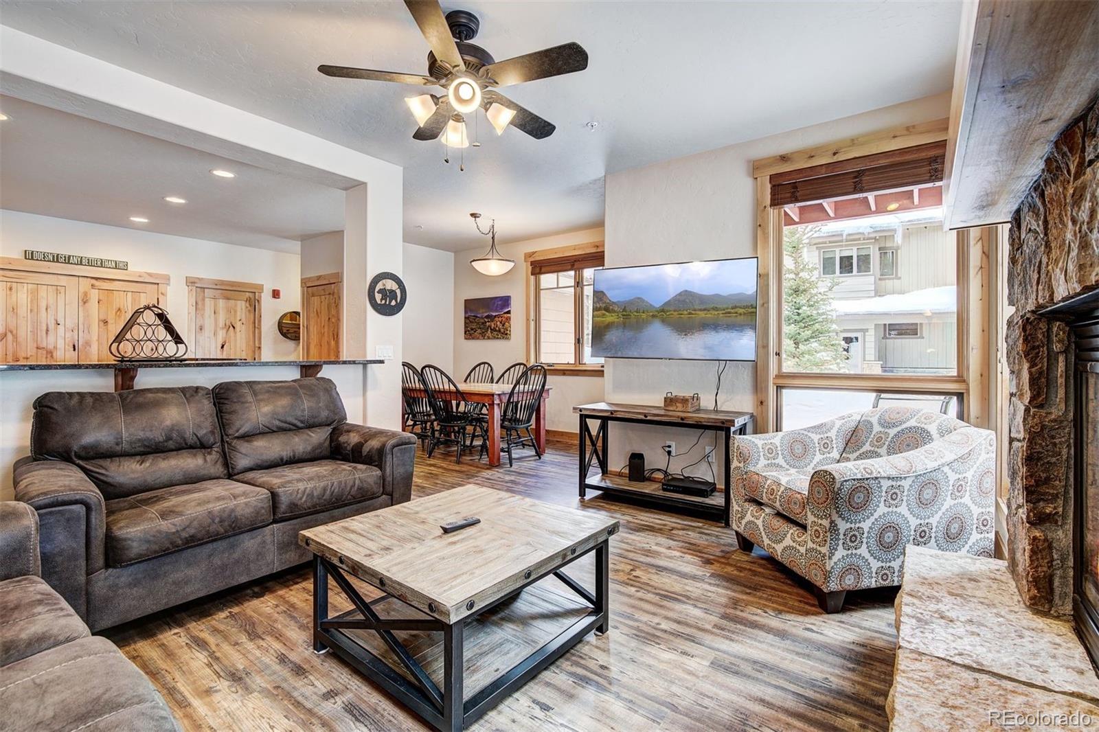 35 Tip Top Trail, Unit 6500 Keystone, CO 80435 - Photo 2 of 24 a living room with furniture a fireplace and a flat screen tv