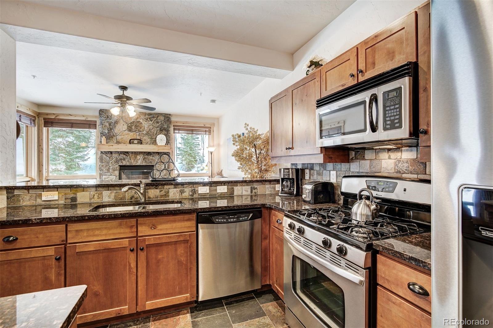 35 Tip Top Trail, Unit 6500 Keystone, CO 80435 - Photo 5 of 24 a kitchen with stainless steel appliances granite countertop a stove sink and cabinets