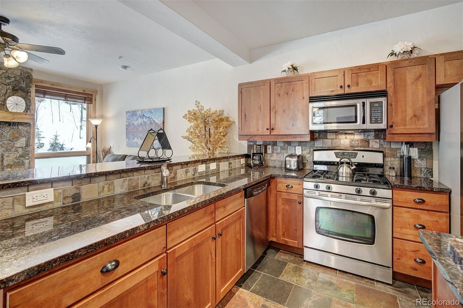 35 Tip Top Trail, Unit 6500 Keystone, CO 80435 - Photo 6 of 24 a kitchen with granite countertop a sink stainless steel appliances and cabinets