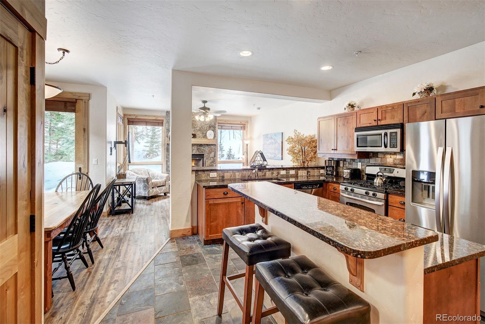 35 Tip Top Trail, Unit 6500 Keystone, CO 80435 - Photo 8 of 24 a kitchen with stainless steel appliances granite countertop a refrigerator a stove and a sink with granite countertops