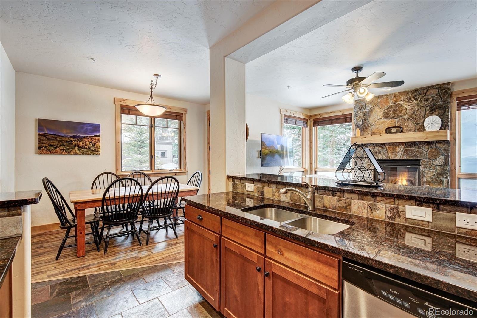 35 Tip Top Trail, Unit 6500 Keystone, CO 80435 - Photo 10 of 24 a kitchen with granite countertop cabinets a dining table and chairs
