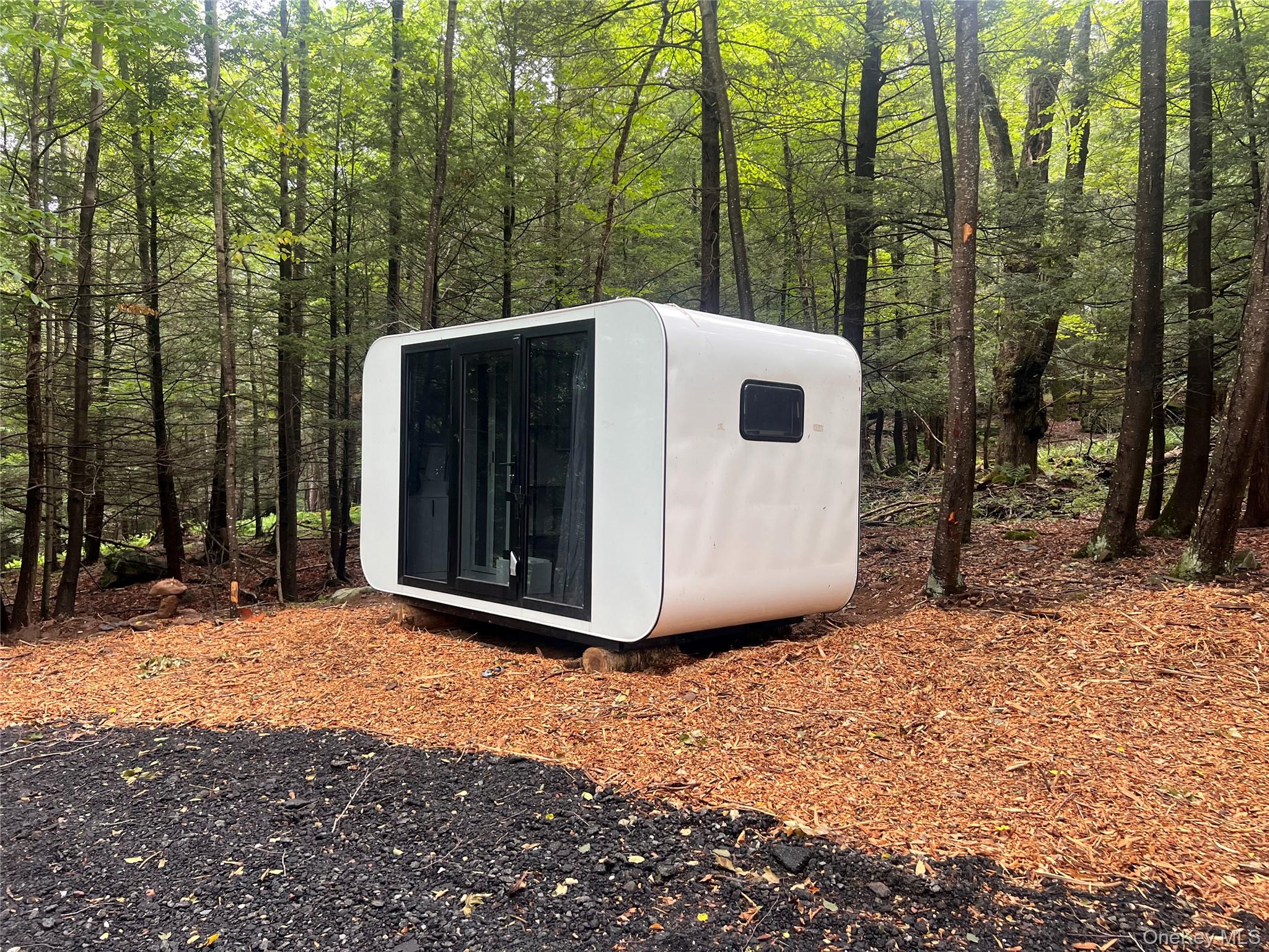 2446 Ulster Heights Road Woodbourne, NY 12788 - Photo 19 of 19 a view of a white house with a large tree and wooden fence