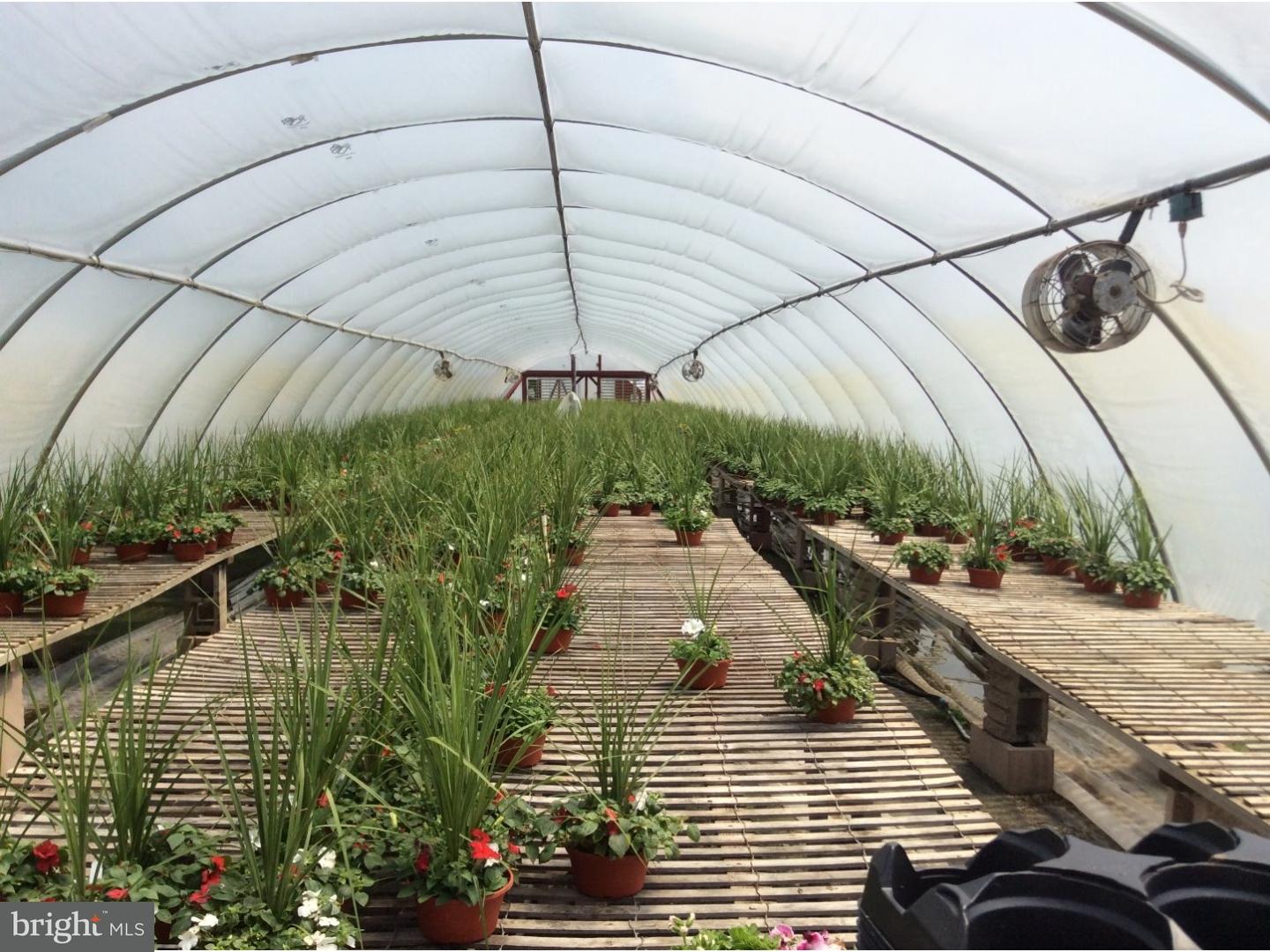 126 Sunset Drive Mannington, NJ 08079 - Photo 21 of 25 a view of a balcony with two chairs under an umbrella