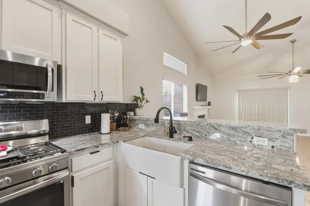a dining room with wooden floor a chandelier a wooden table and chairs