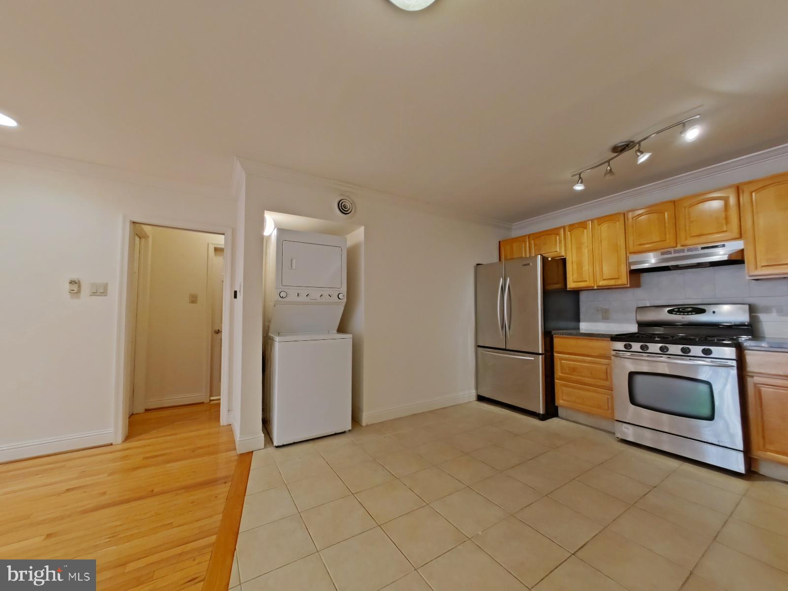 610-12 Bainbridge Street, Unit 2 Philadelphia, PA 19147 - Photo 11 of 23 a kitchen with a refrigerator and a stove top oven