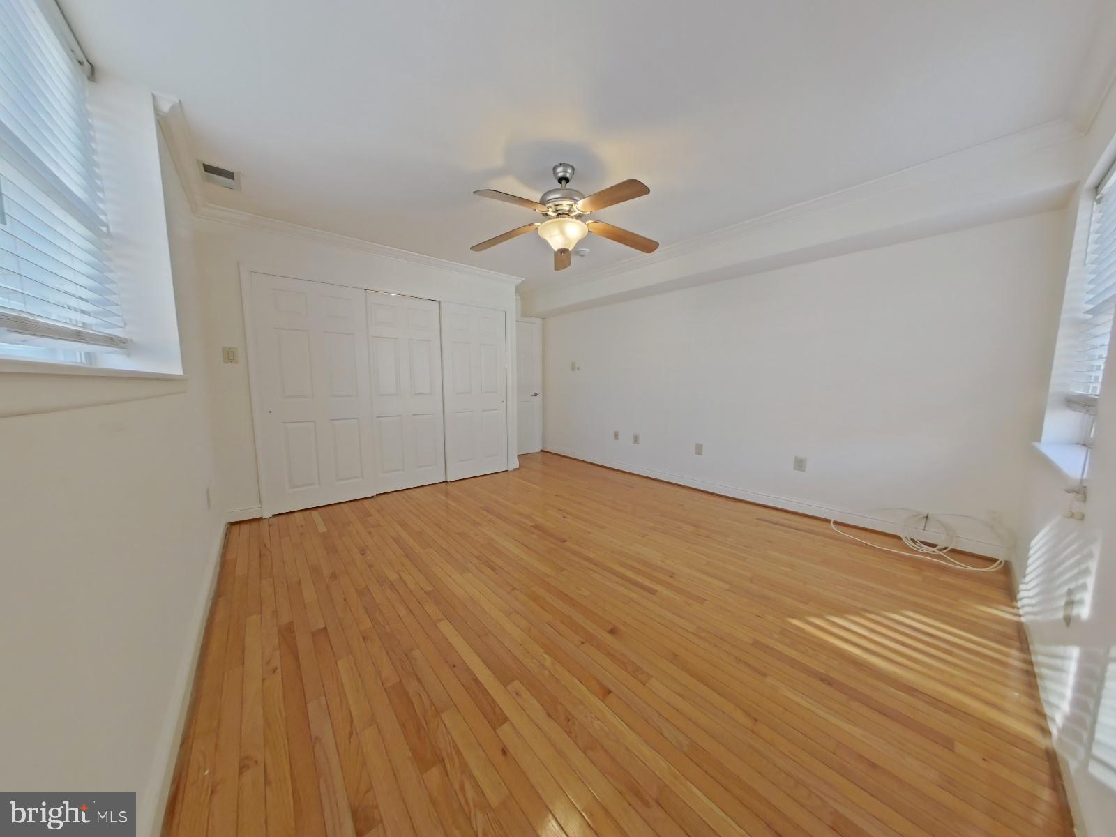 610-12 Bainbridge Street, Unit 2 Philadelphia, PA 19147 - Photo 14 of 23 a view of a big room with wooden floor and a ceiling fan