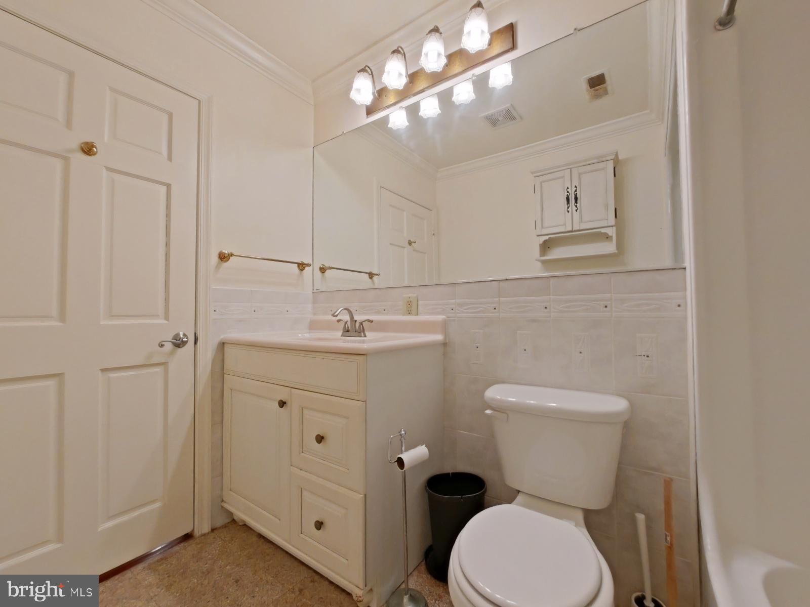 610-12 Bainbridge Street, Unit 2 Philadelphia, PA 19147 - Photo 18 of 23 a bathroom with a toilet a sink and mirror