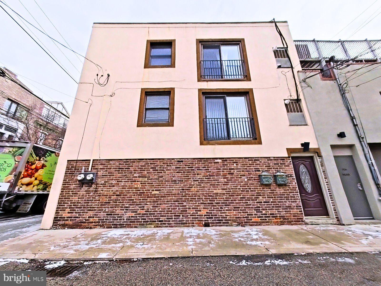 610-12 Bainbridge Street, Unit 2 Philadelphia, PA 19147 - Photo 23 of 23 a view of a brick house with many windows