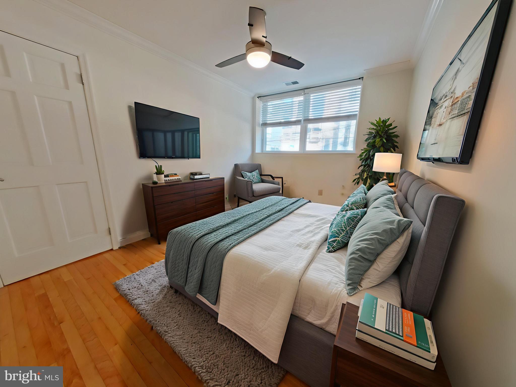 610-12 Bainbridge Street, Unit 2 Philadelphia, PA 19147 - Photo 5 of 23 a bedroom with a bed and a flat screen tv