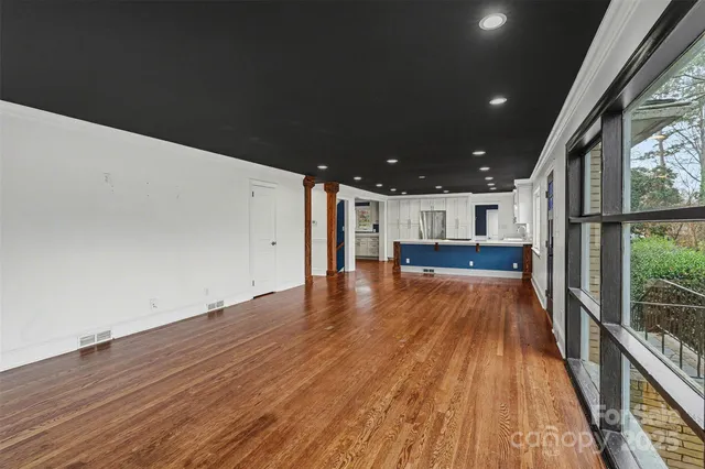 a view of kitchen with wooden floor and electronic appliances