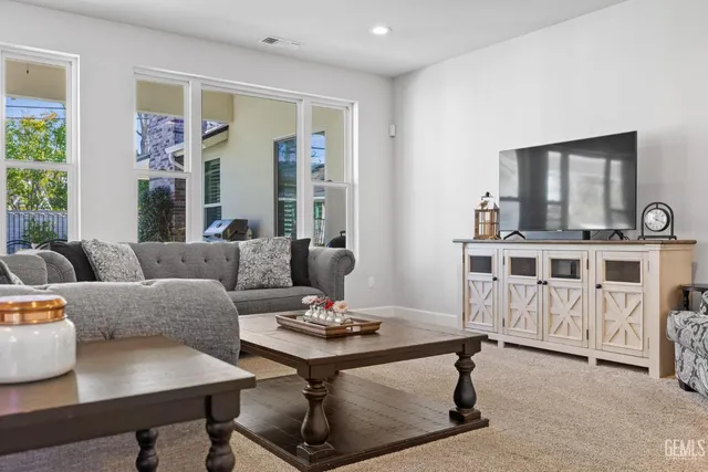 a view of a hallway with wooden floor and windows