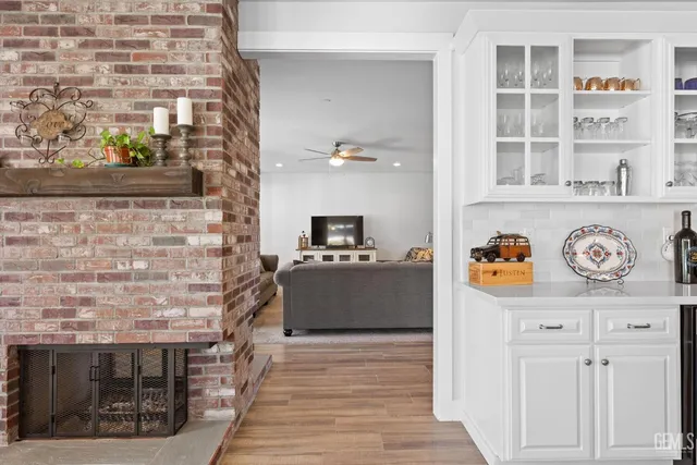 a kitchen with stainless steel appliances granite countertop a table chairs sink and cabinets