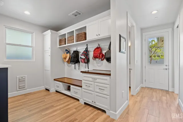 a spacious bathroom with a double vanity sink a mirror and a bathtub