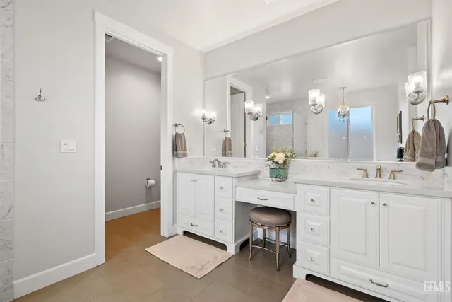 a view of a patio with table and chairs under an umbrella