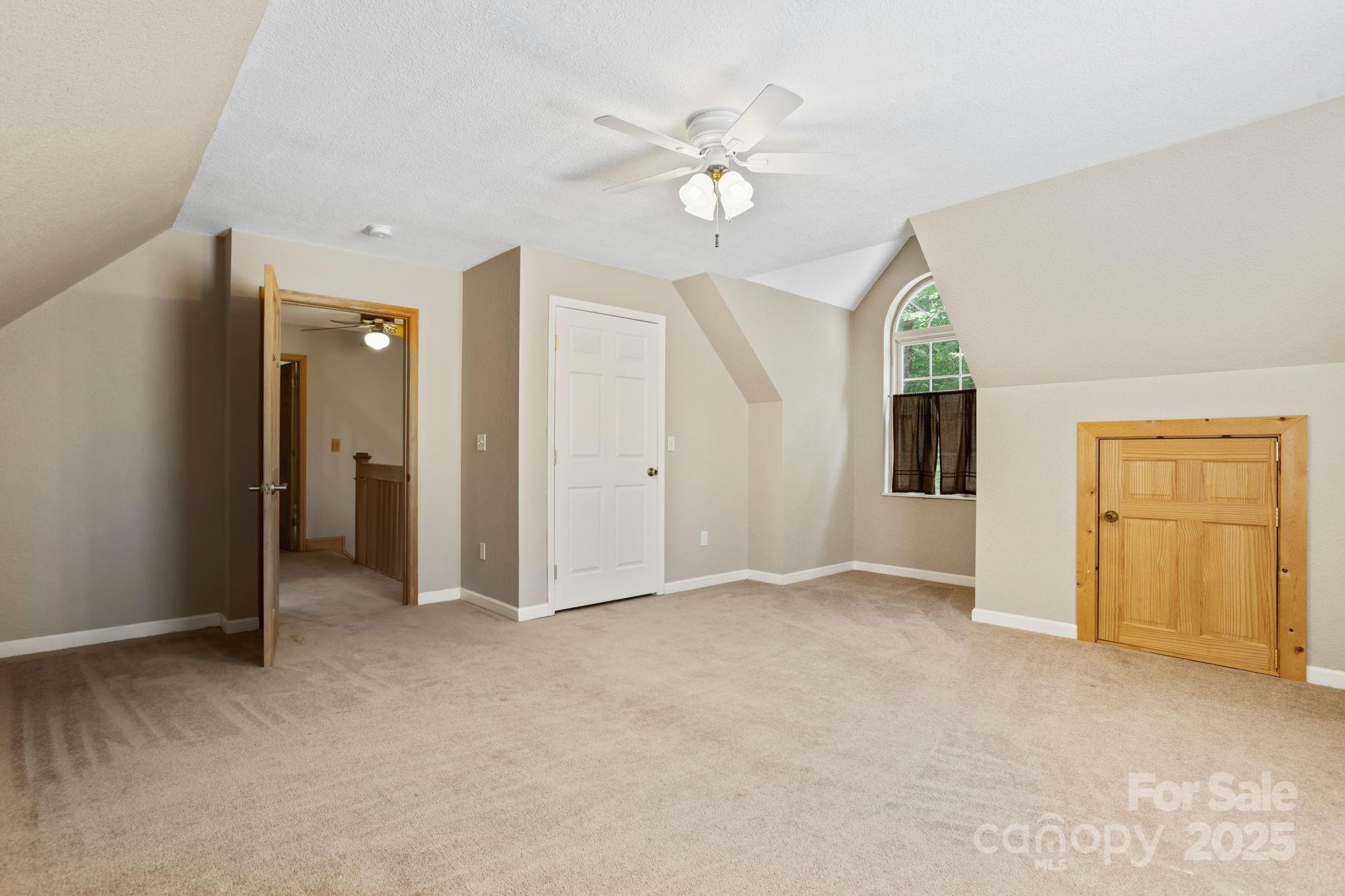 55 Vintage Road Candler, NC 28715 - Photo 27 of 47 an empty room with chandelier fan and windows