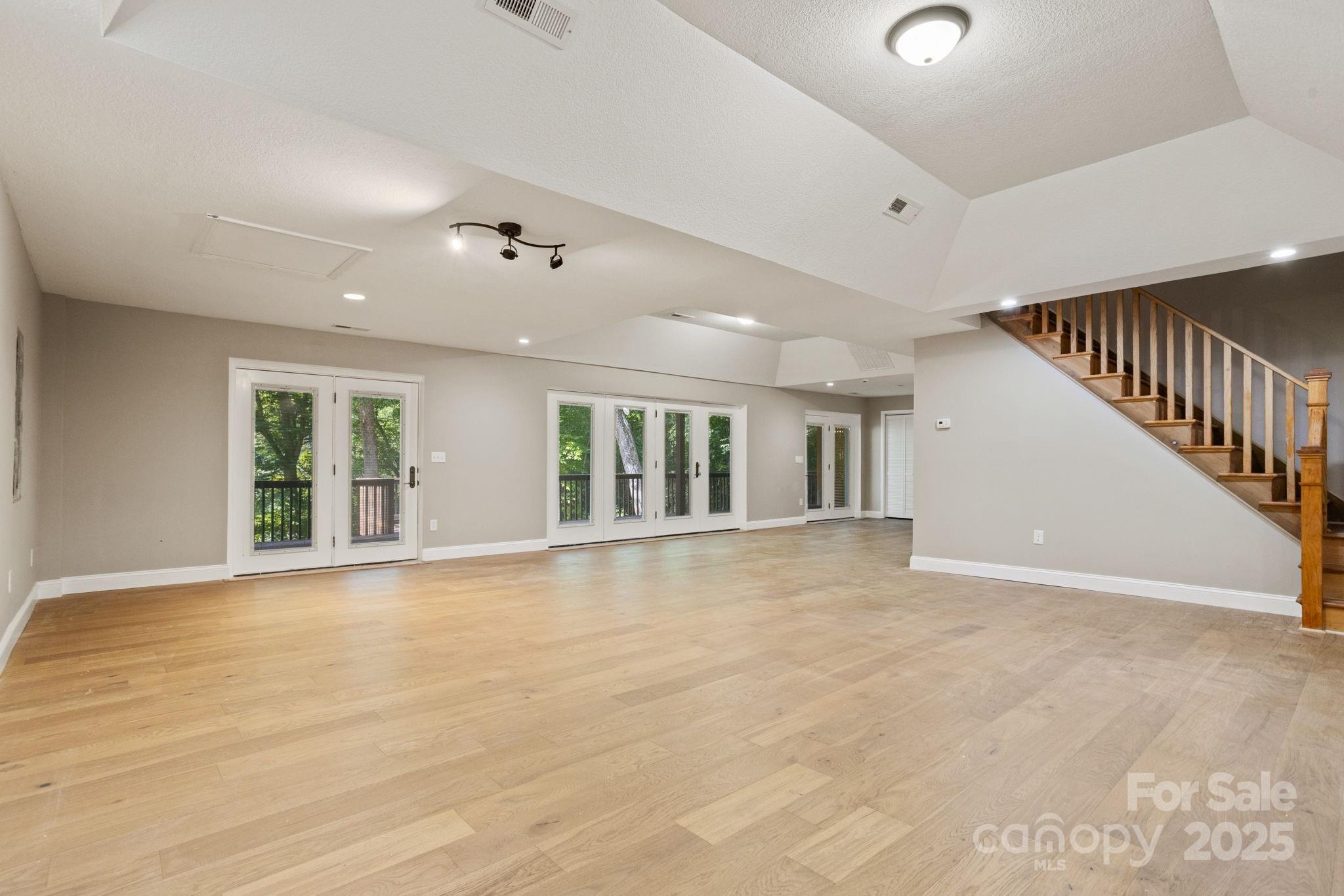 55 Vintage Road Candler, NC 28715 - Photo 28 of 47 a view of an empty room with wooden floor and a window