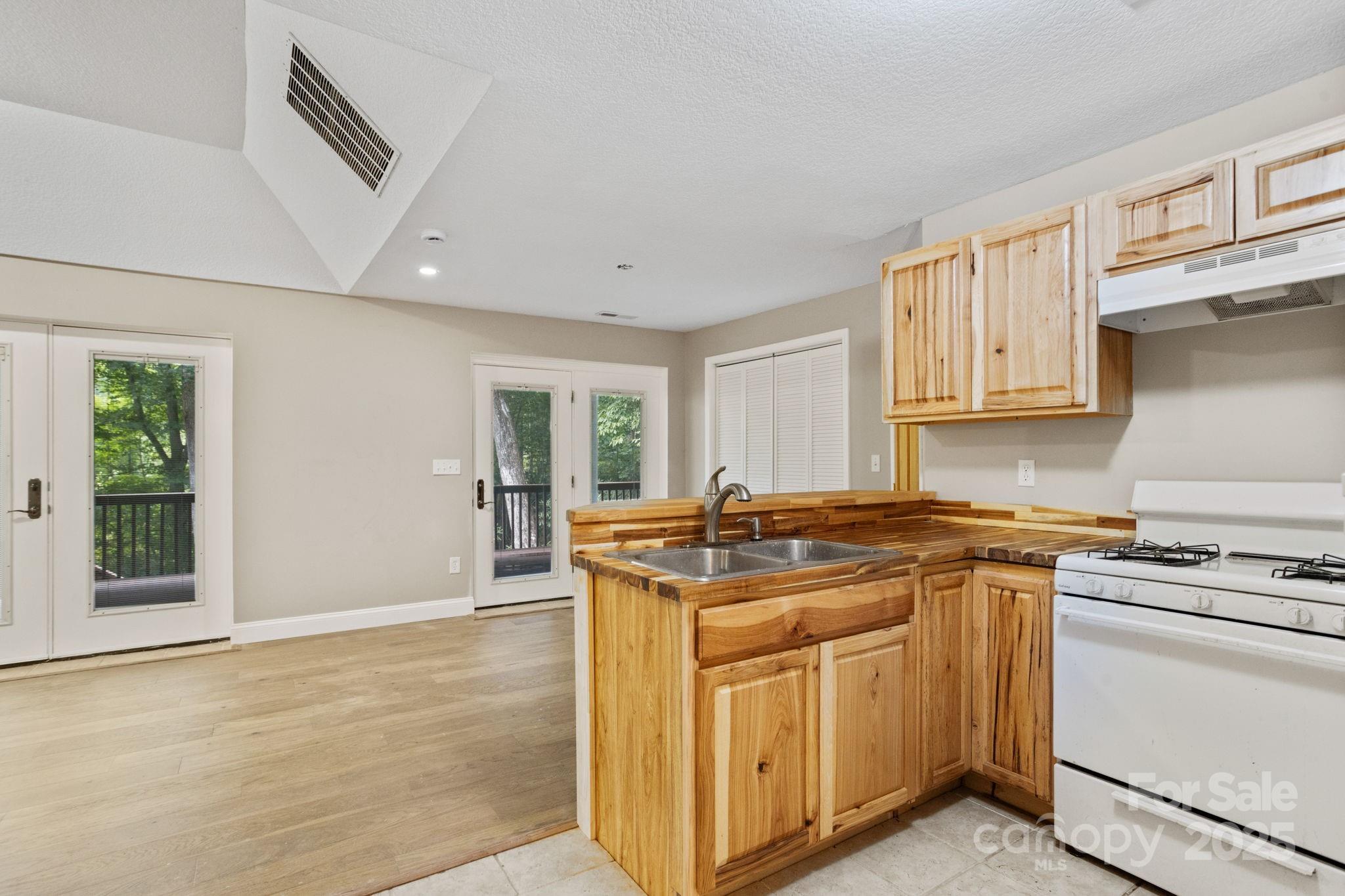 55 Vintage Road Candler, NC 28715 - Photo 33 of 47 a kitchen with stainless steel appliances granite countertop a stove and a sink
