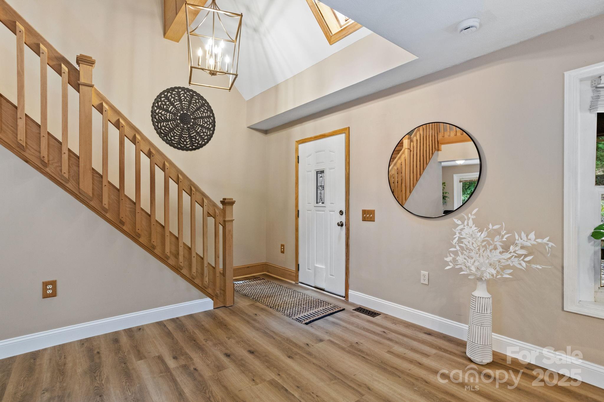 55 Vintage Road Candler, NC 28715 - Photo 8 of 47 a view of a hallway with wooden floor and a front door