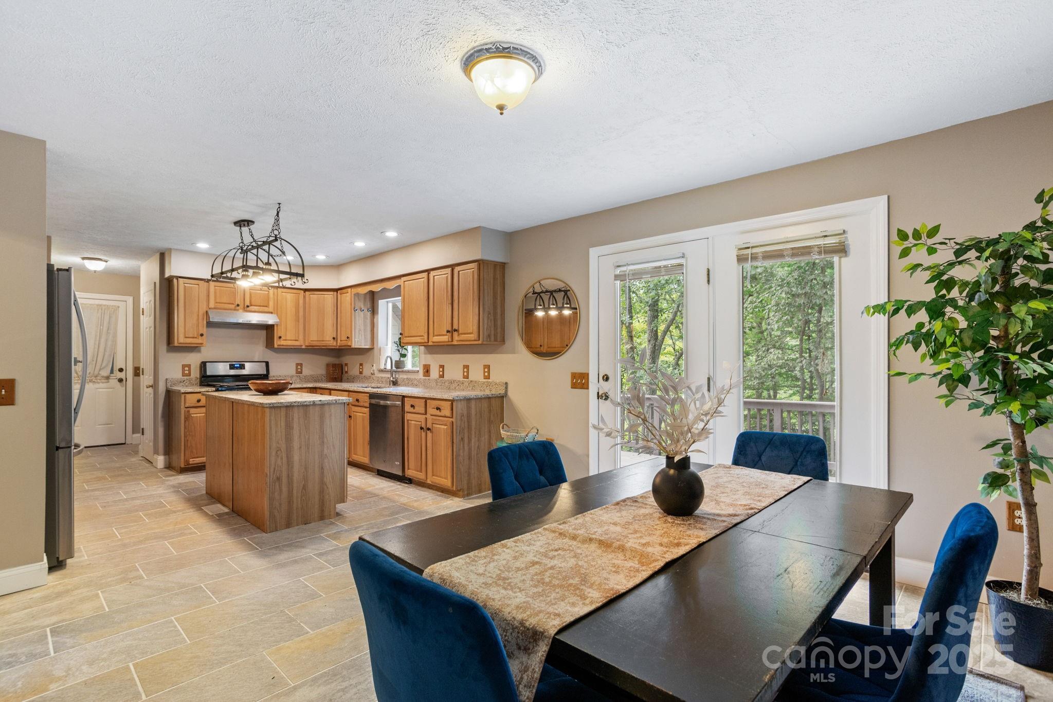 55 Vintage Road Candler, NC 28715 - Photo 9 of 47 a living room with kitchen island furniture and a large window