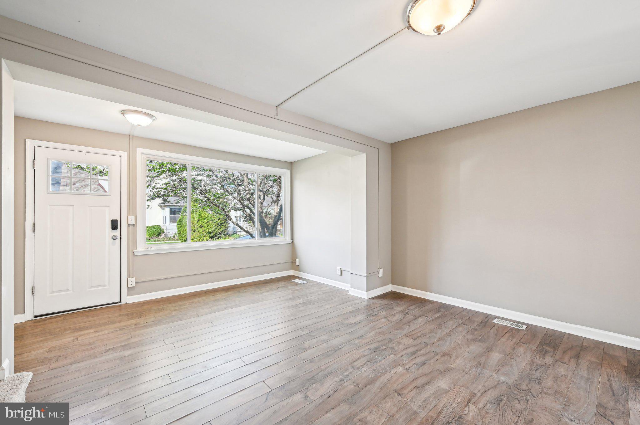 11 Kinship Road Dundalk, MD 21222 - Photo 7 of 46 a view of an empty room with wooden floor and a window