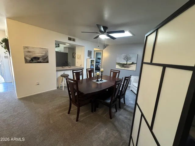 a view of a dining room with furniture and a chandelier