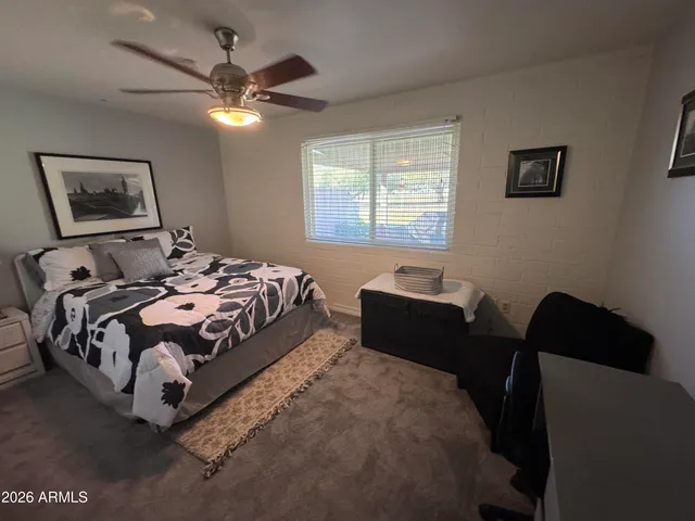 a bedroom with bed window and couch