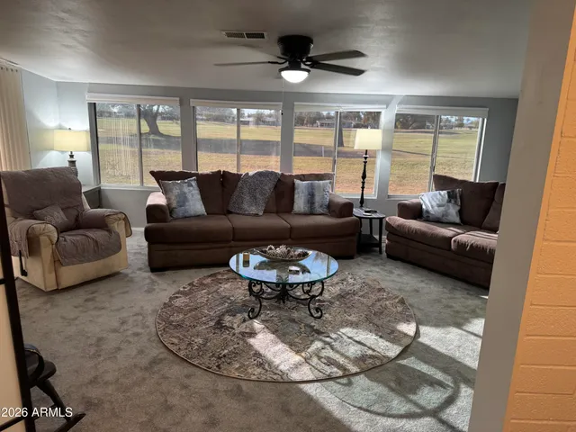 a living room with furniture and a large window