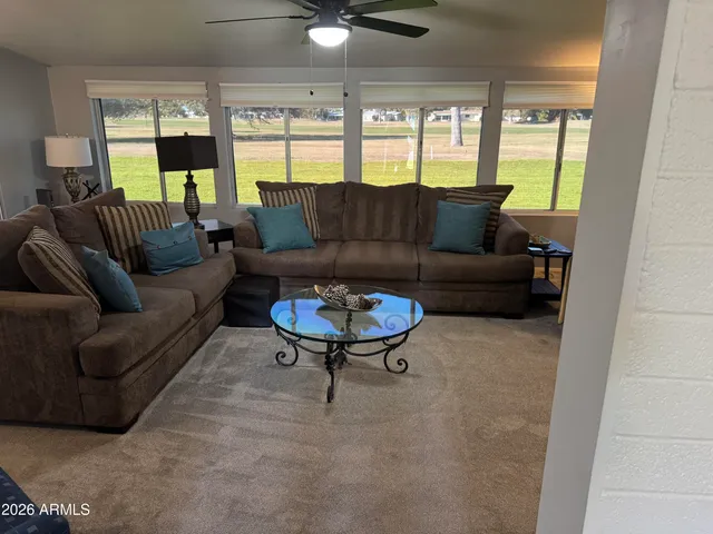 a living room with furniture and a large window