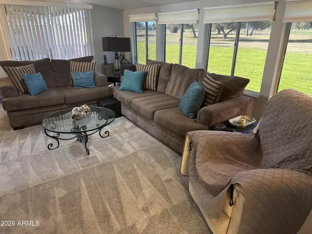 a living room with furniture and a large window