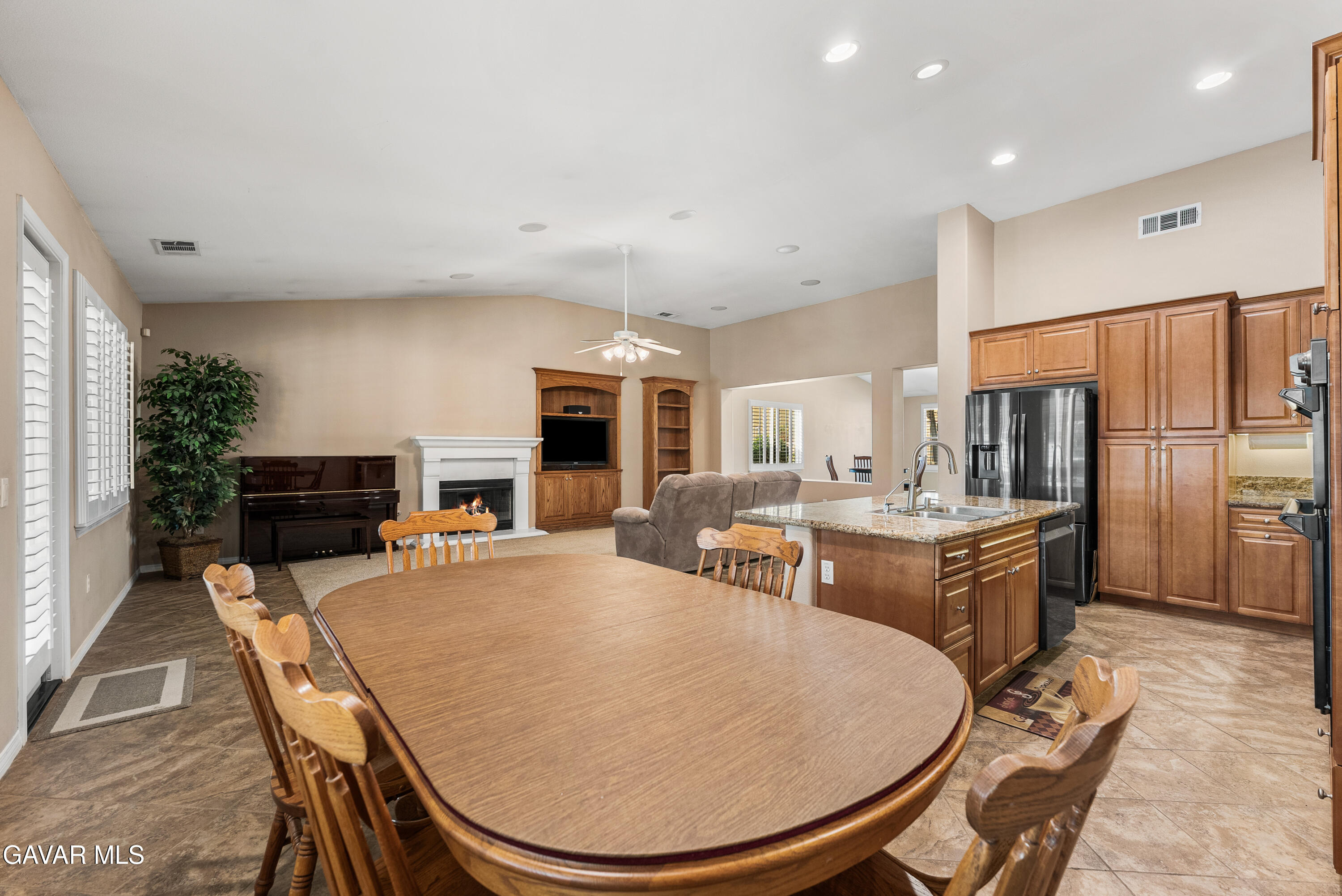 3724 Neola Way Lancaster, CA 93536 - Photo 11 of 31 a living room with stainless steel appliances furniture a flat screen tv and a kitchen view