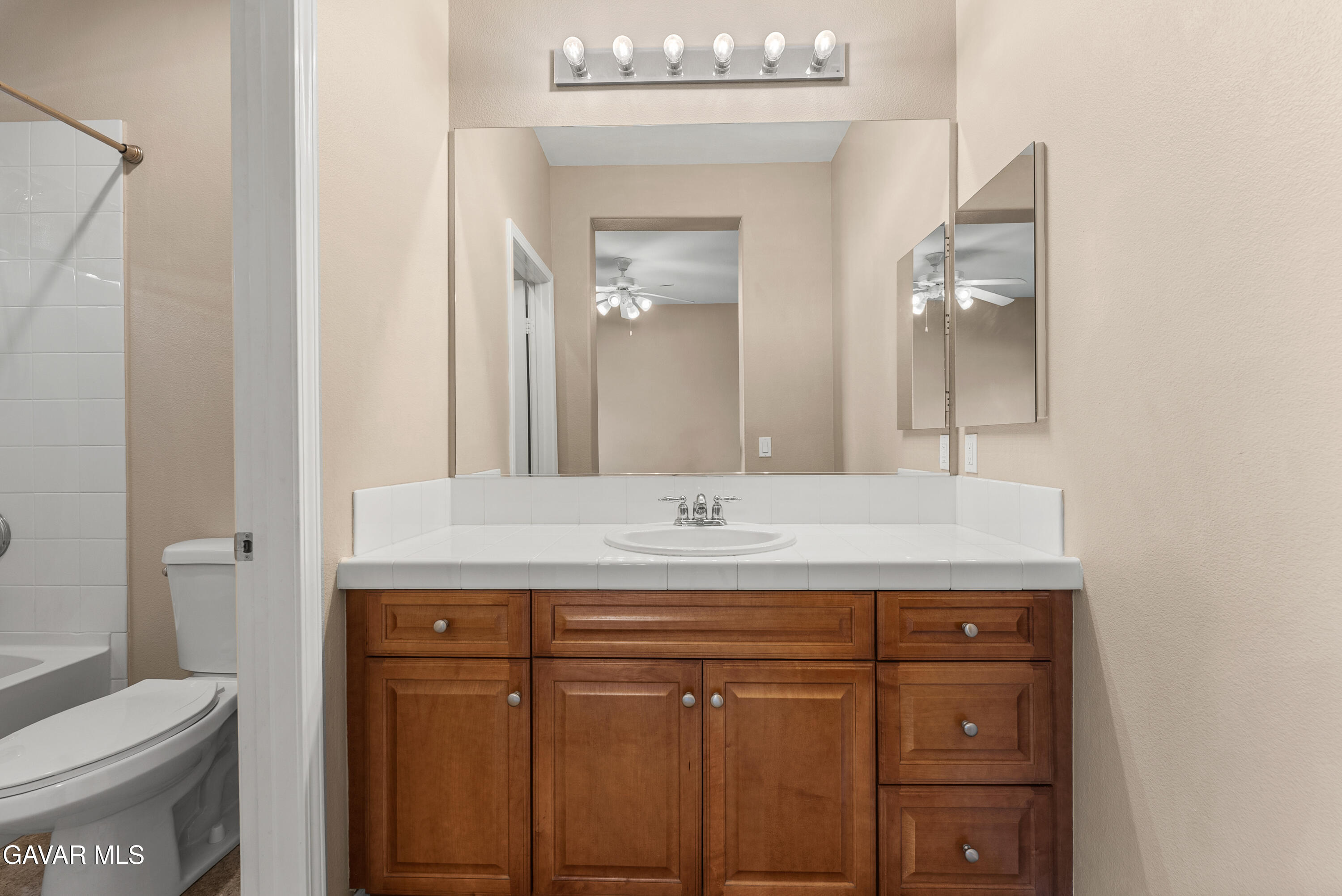 3724 Neola Way Lancaster, CA 93536 - Photo 16 of 31 a bathroom with a granite countertop sink a toilet and a mirror