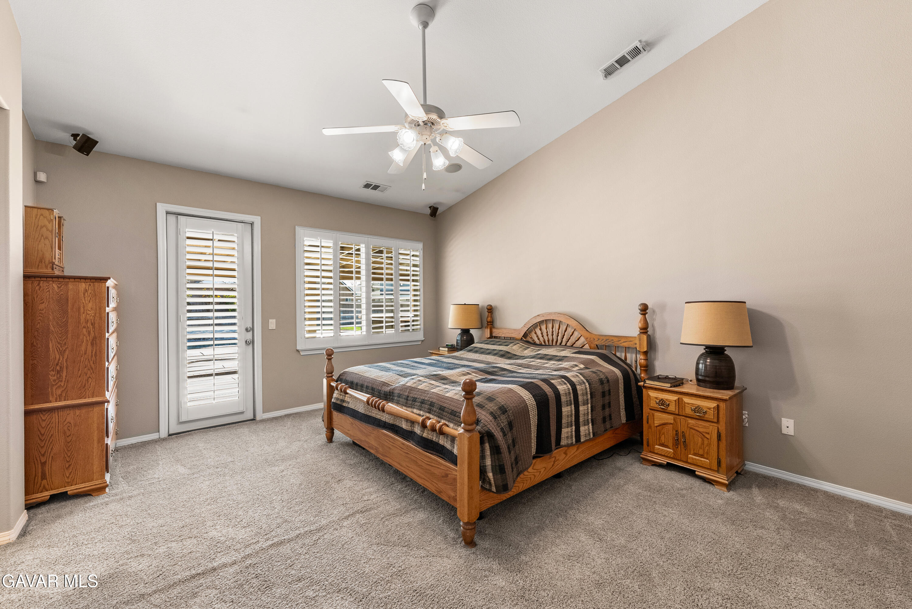 3724 Neola Way Lancaster, CA 93536 - Photo 19 of 31 a spacious bedroom with a bed and a chandelier