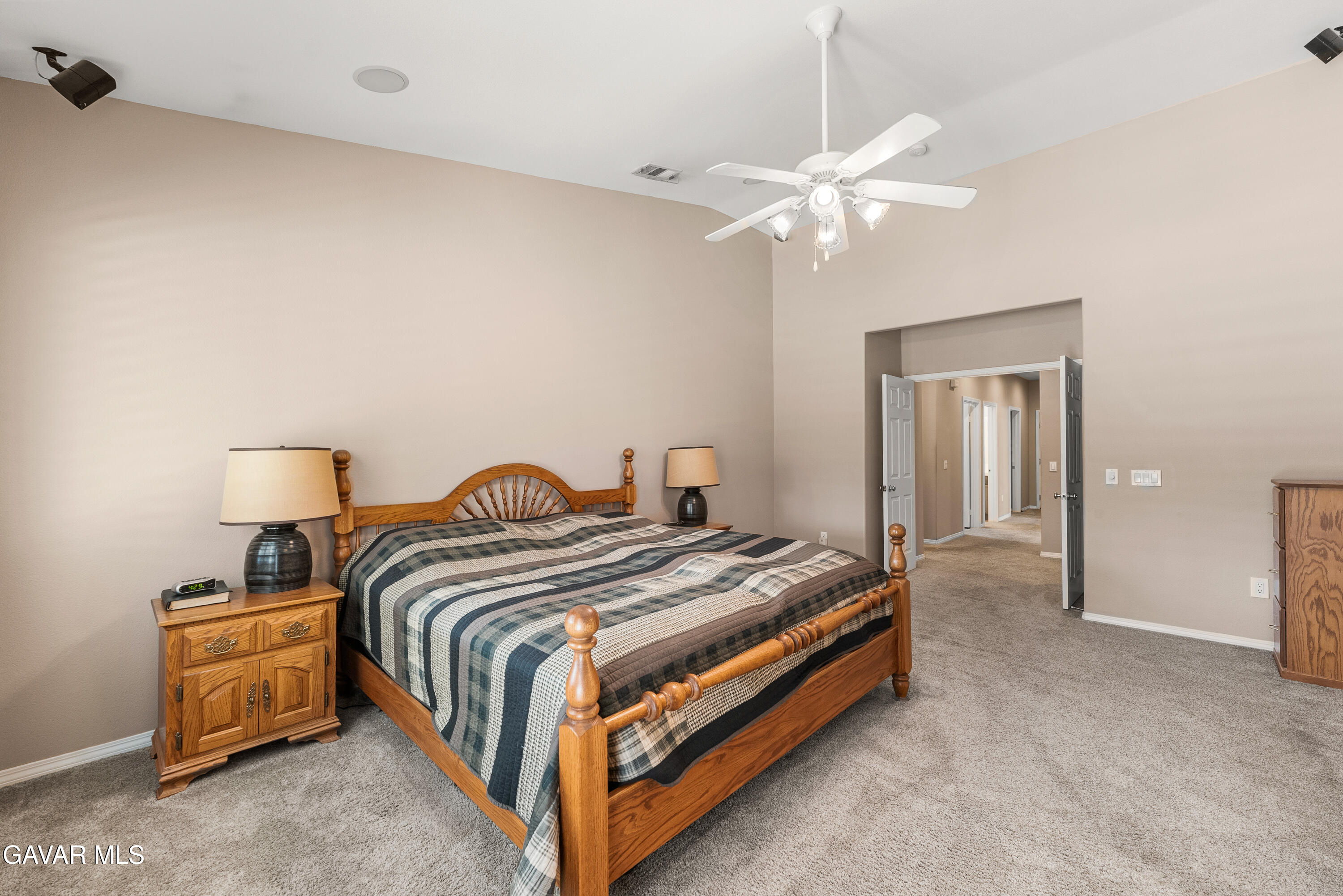 3724 Neola Way Lancaster, CA 93536 - Photo 21 of 31 a bedroom with a bed and a chandelier