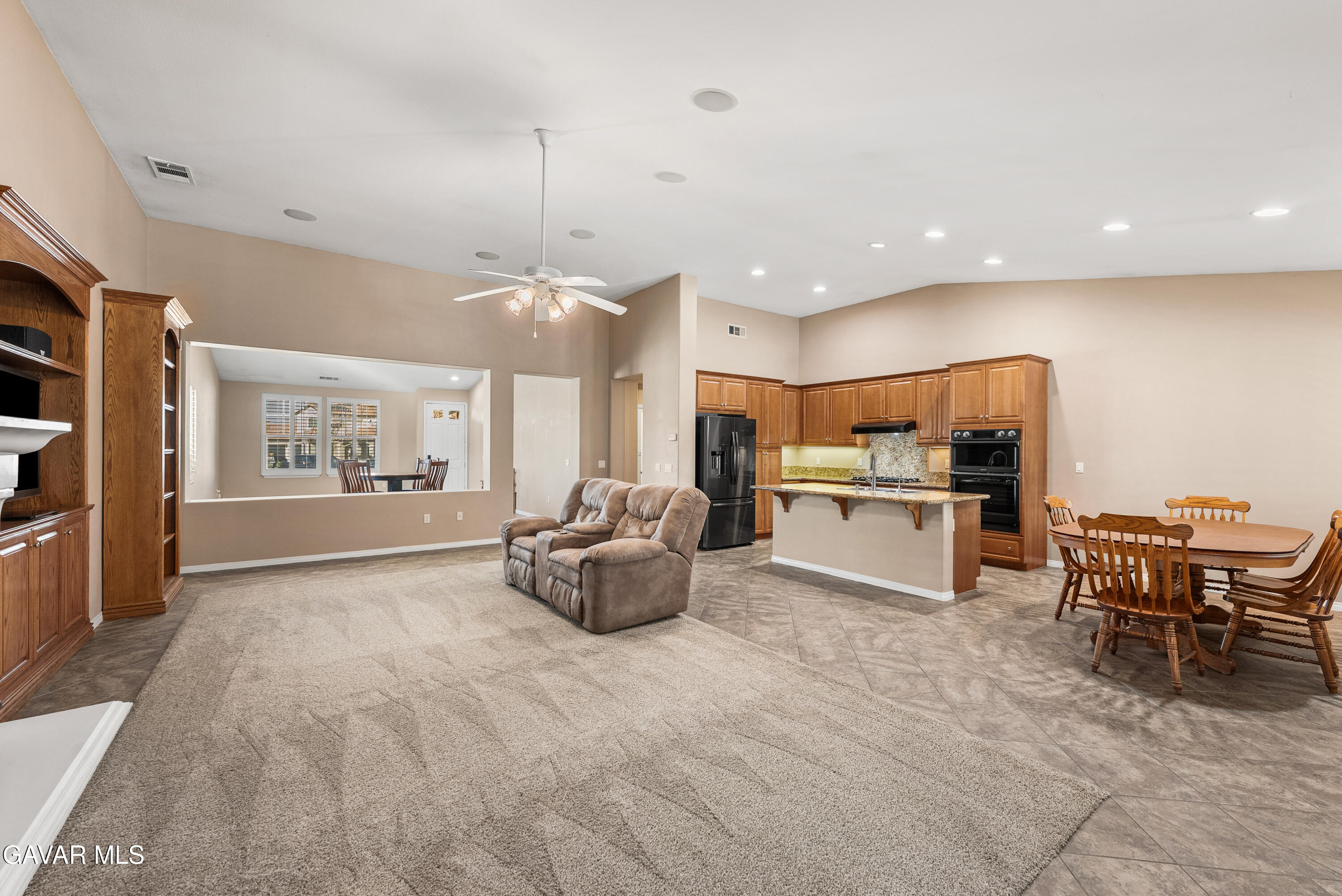 3724 Neola Way Lancaster, CA 93536 - Photo 7 of 31 a living room with kitchen island furniture and a potted plant