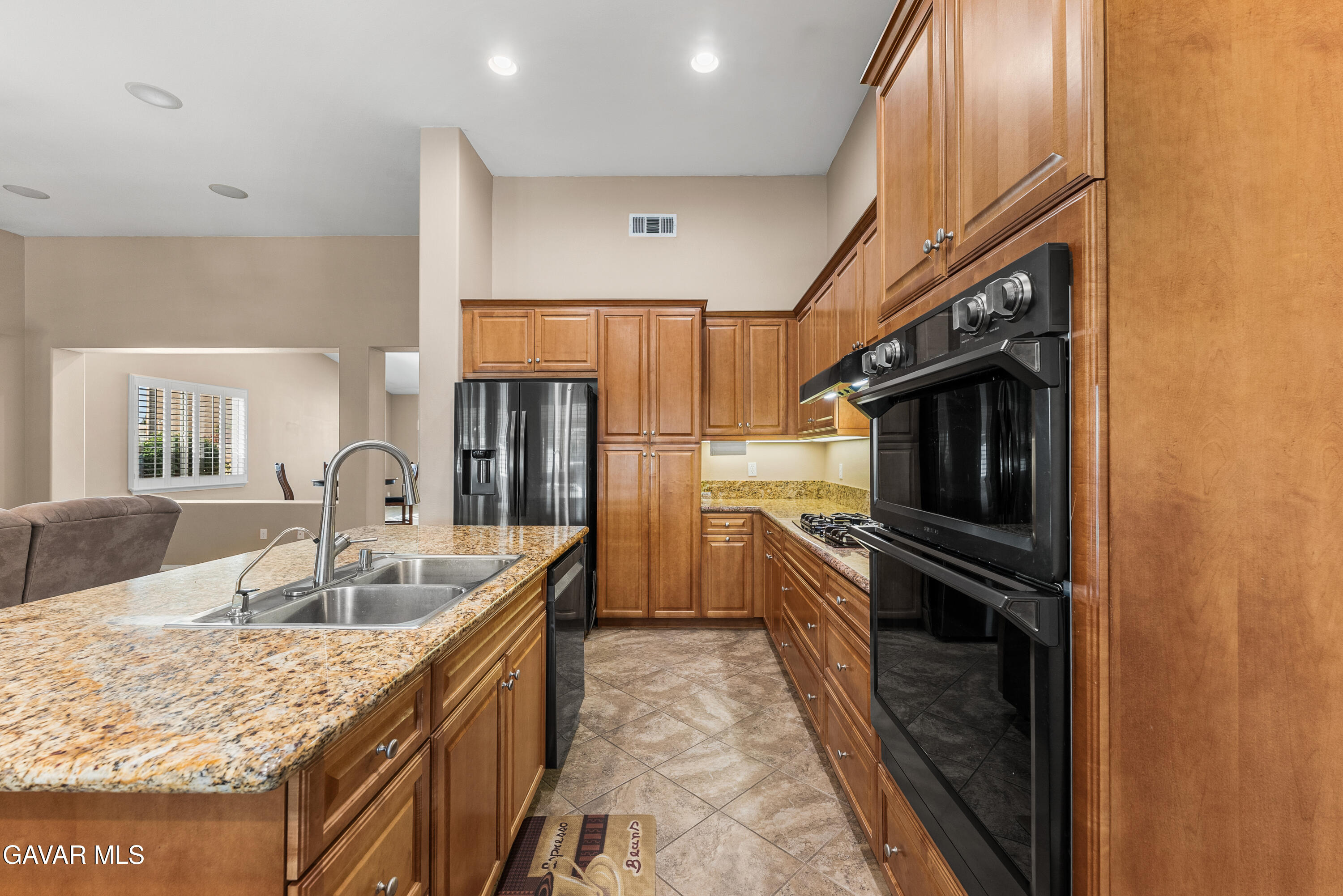 3724 Neola Way Lancaster, CA 93536 - Photo 10 of 31 a kitchen with granite countertop a refrigerator and a sink