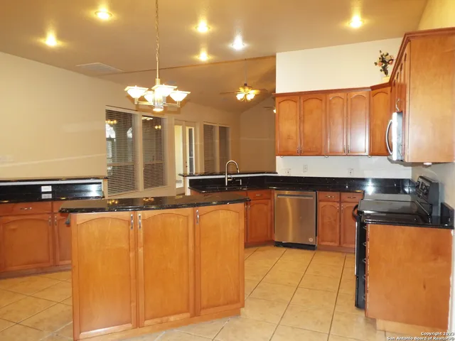 a large kitchen with a sink and cabinets
