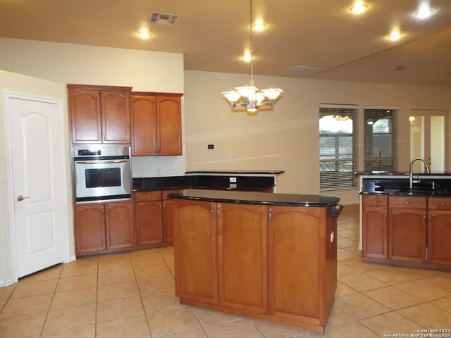 a large kitchen with stainless steel appliances a stove a sink dishwasher and microwave