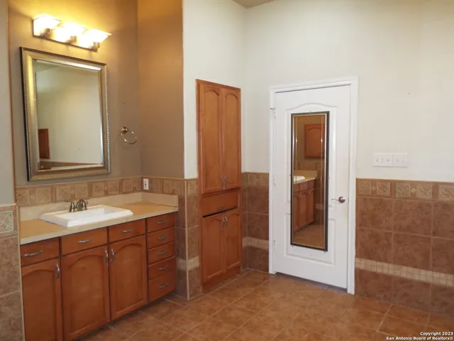 a bathroom with a double vanity sink and mirror