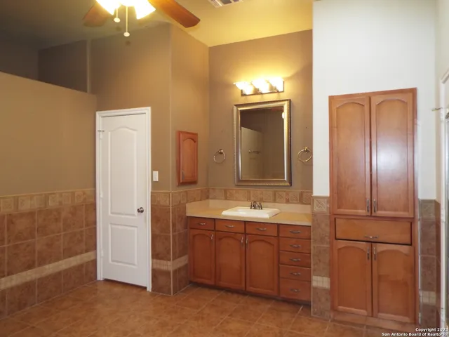 a bathroom with a double vanity sink and a mirror