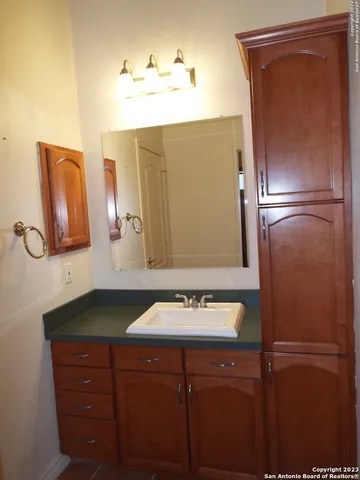 a bathroom with a sink a mirror and a vanity